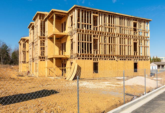 a close-up of temporary chain link fences enclosing a job site, signaling progress in the project's development in Archdale, NC